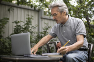 senior-man-doing-online-classes-laptop